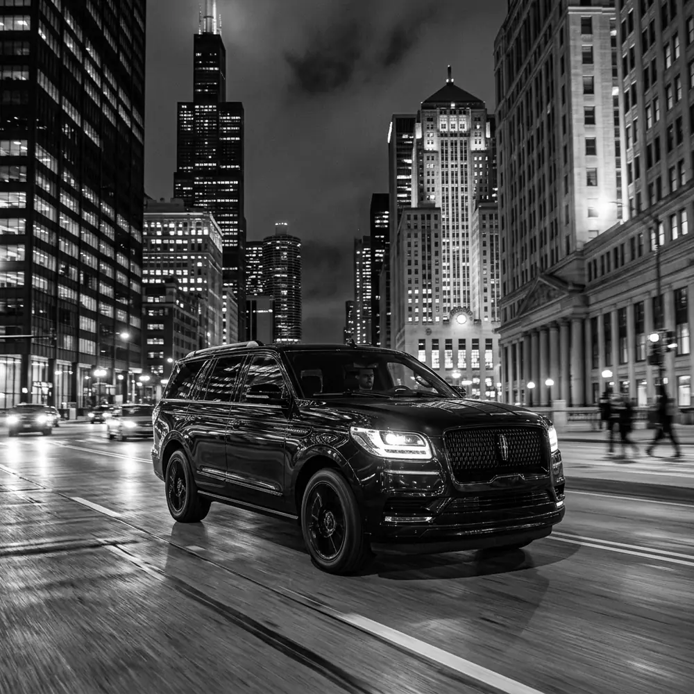 Black Lincoln Navigator on a downtown Chicago street at night